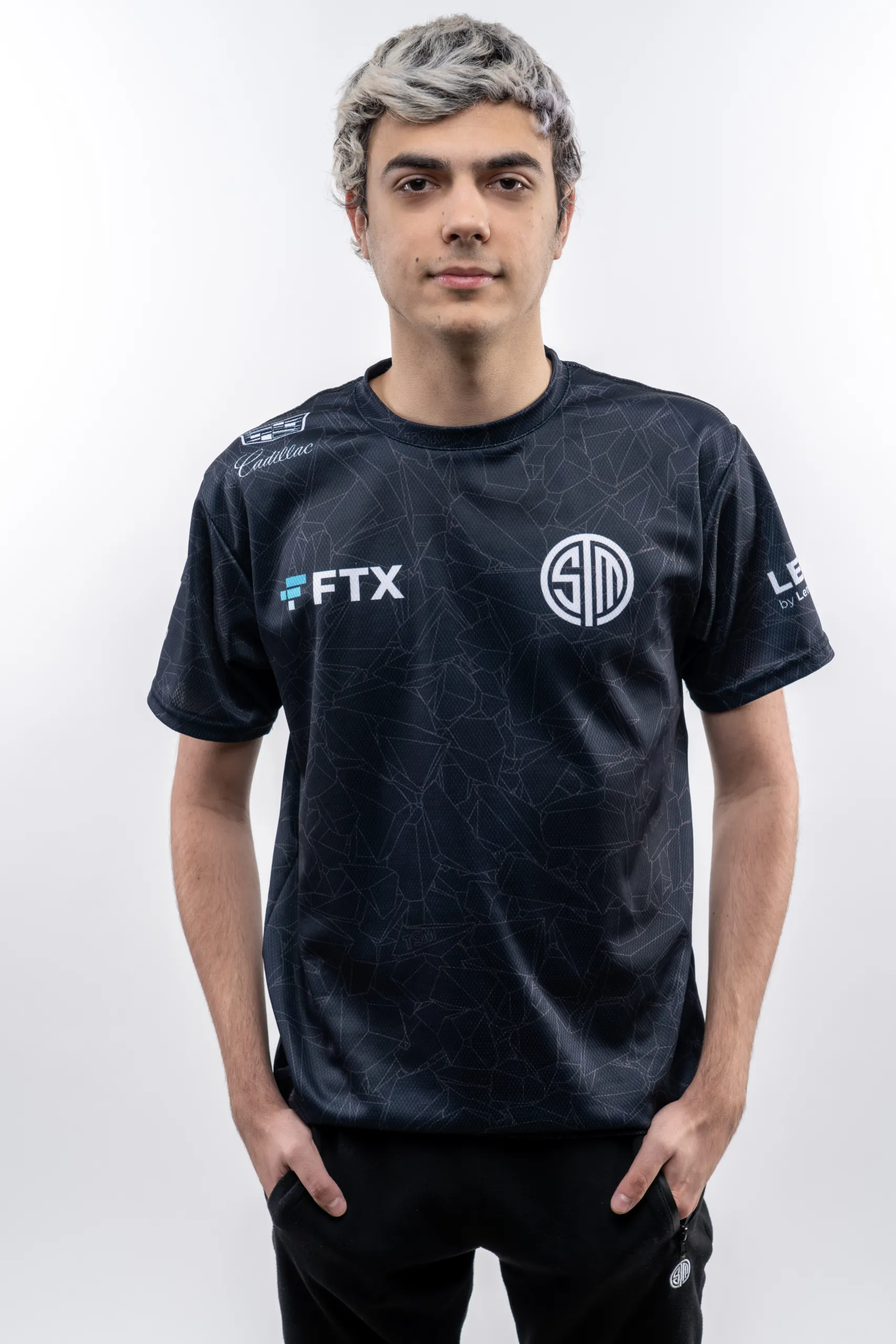 ImperialHal posing in his TSM jersey in front of a white background with his hands in his pockets